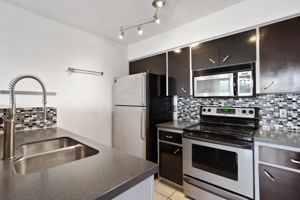 Awesome contemporary kitchen. All stainless steel appliances convey!