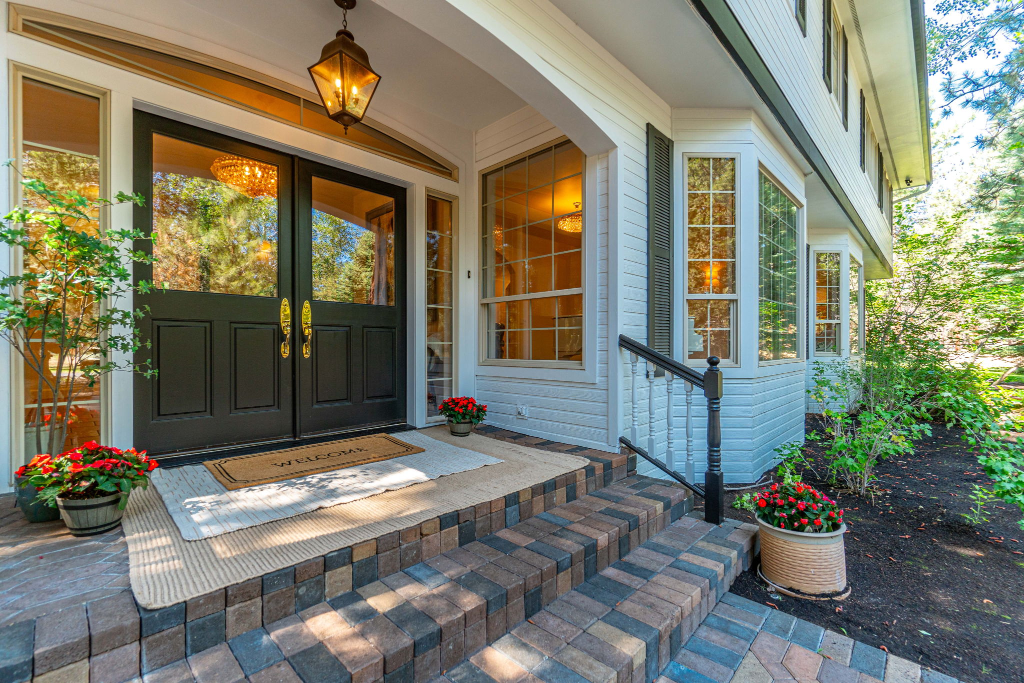 Welcoming Double door entry with paver walkway