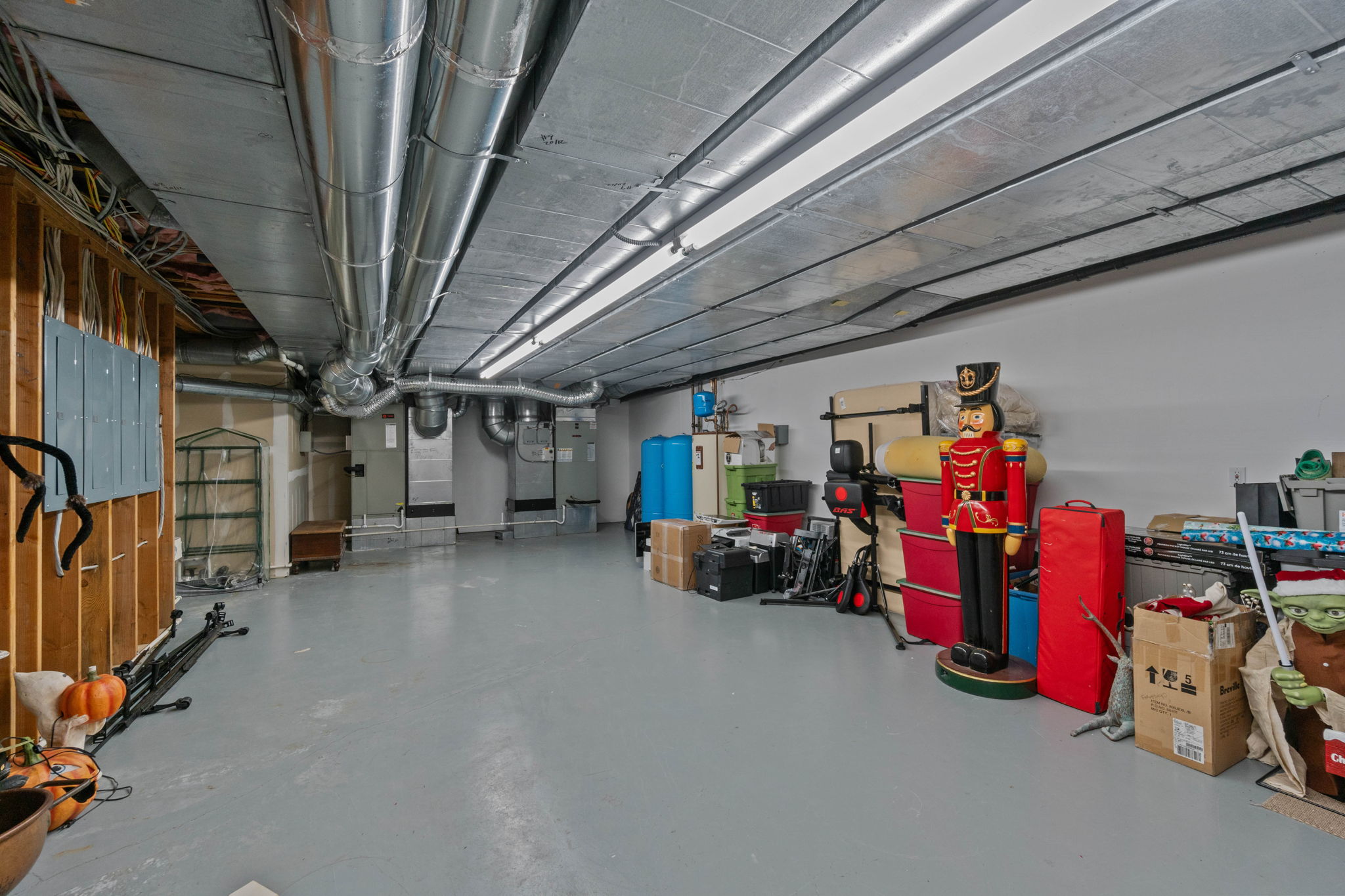 Large storage & mechanical room with 4 Electrical Panels, 3 HVAC units with multiple zones, 119 gallon water heater