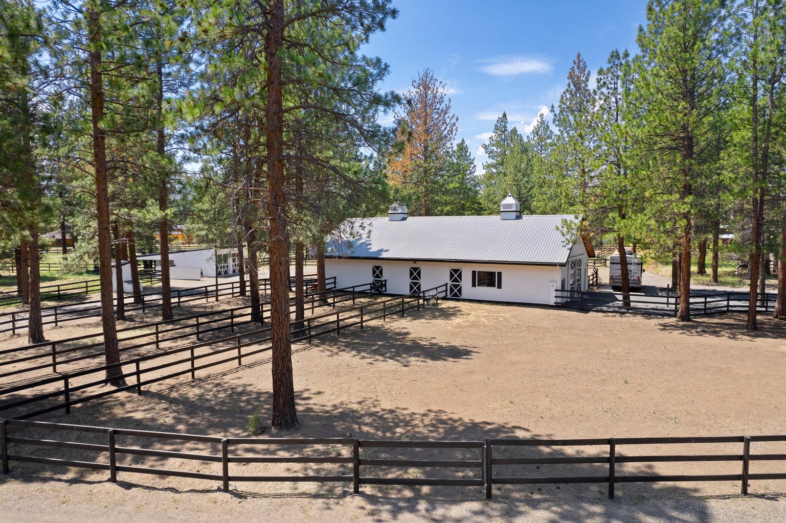 Stately 6 stall barn with 6 paddocks & copolas with weather vanes