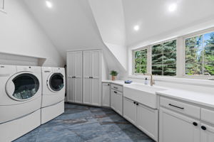 Large, updated laundry room with new farmhouse sink, plumbing fixtures, hardware, flooring