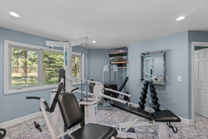 Home workout room offers high end equipment; Vector Weight Station 1850, Life Fitness Treadmill & wall mounted TV included