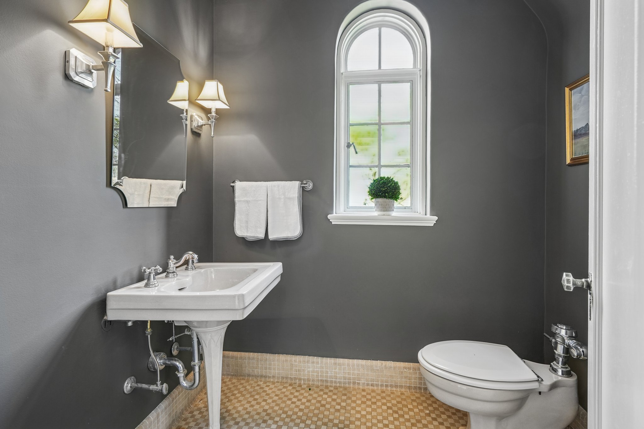 First floor powder room. The house has 4 full baths and one half bath: 2 full baths on 2nd floor, 1 full bath on lower level, 1 full bath plus this powder room on first floor.