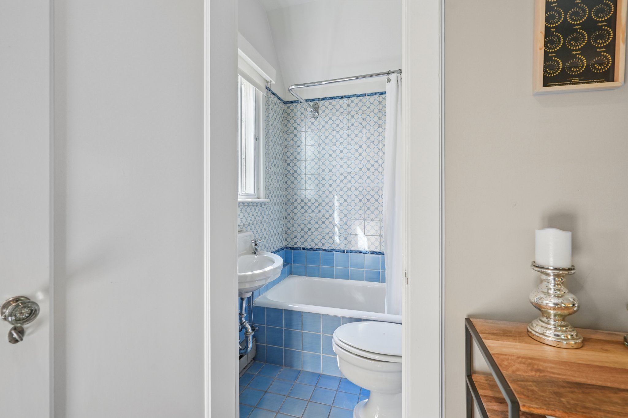 Vintage blue, forever cool. This bathroom’s original tile isn’t just a color—it’s an attitude. Fresh, timeless, and ready for its next era.