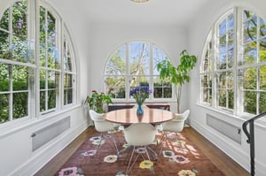 The solarium/sunroom off the living room boasts natural light, cozy vibes, and the perfect place for game night showdowns.