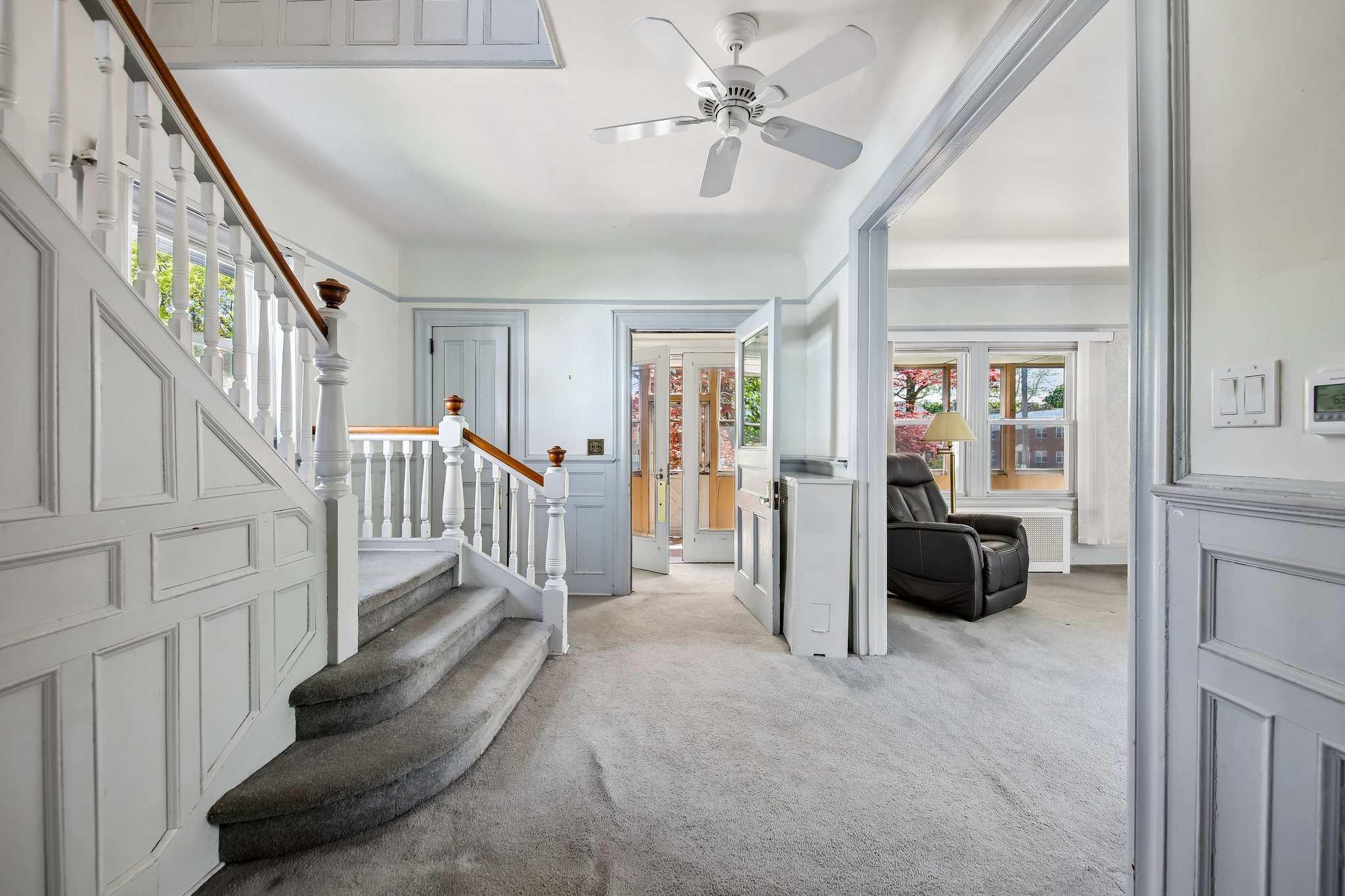 Paneled walls, turned balusters, and that graceful curve in the stair that feels almost sculptural. You can feel the decades of family life layered into it… footsteps up and down those stairs, doors opening and closing, mornings, holidays, everything in between.