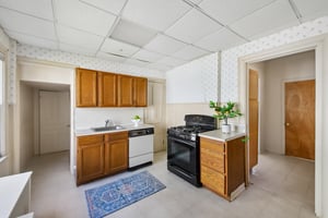 Kitchen with adjacent Butler's Pantry and Full Bath at the end of the hallway.