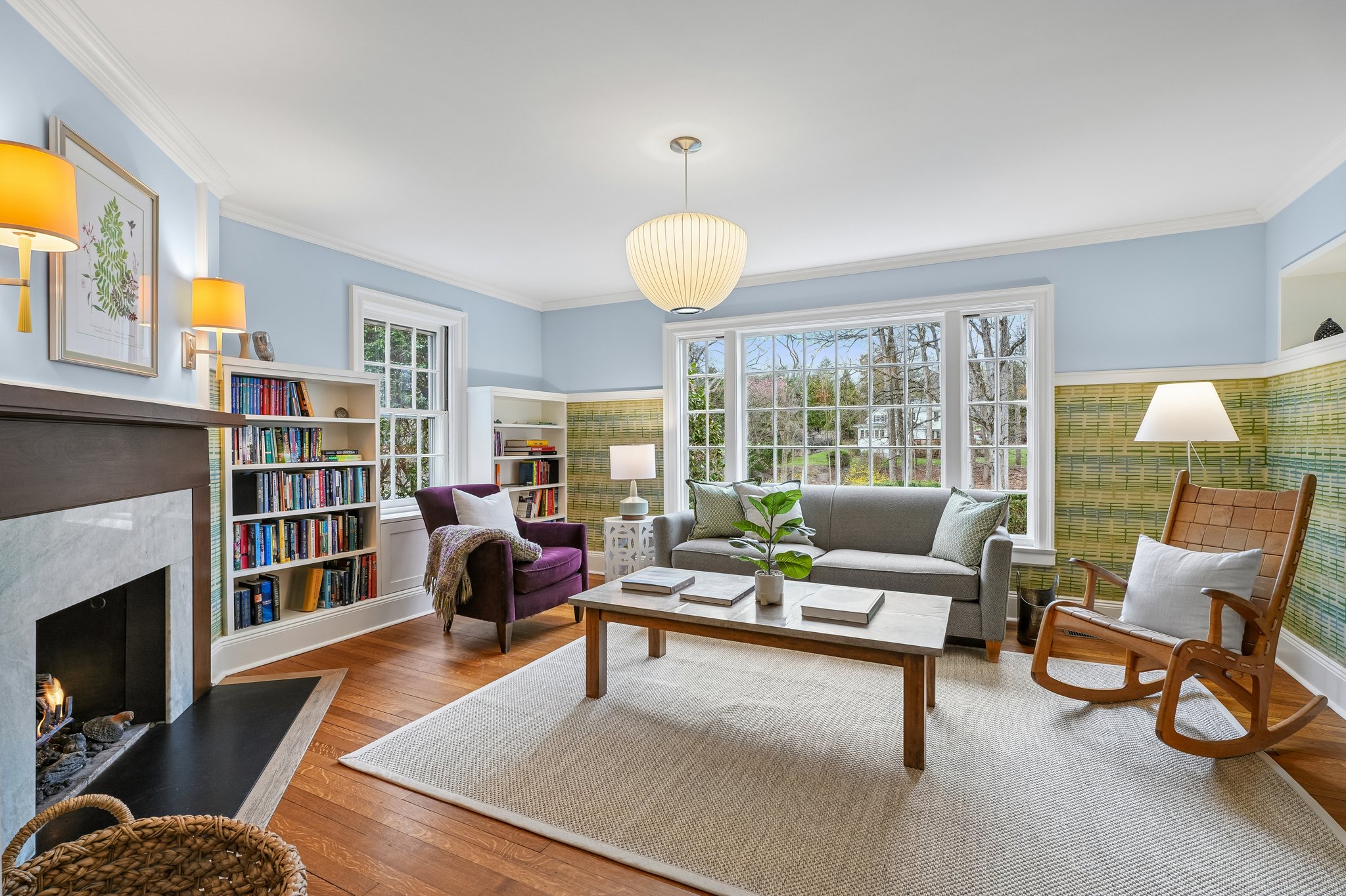 Warm, inviting, and filled with character, the family room centers around a cozy fireplace with built-ins and leafy views beyond - the kind of space that naturally draws everyone in.