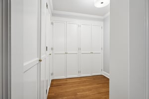 Primary dressing room with custom closets.