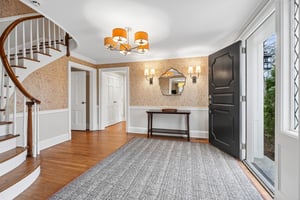 Inviting entry with curved staircase.