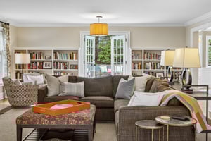 Freshly painted and filled with light, this living room draws you outward with doors to the patio and views of the pool beyond - a seamless connection between inside and out.
