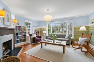 Warm, inviting, and filled with character, the family room centers around a cozy fireplace with built-ins and leafy views beyond - the kind of space that naturally draws everyone in.