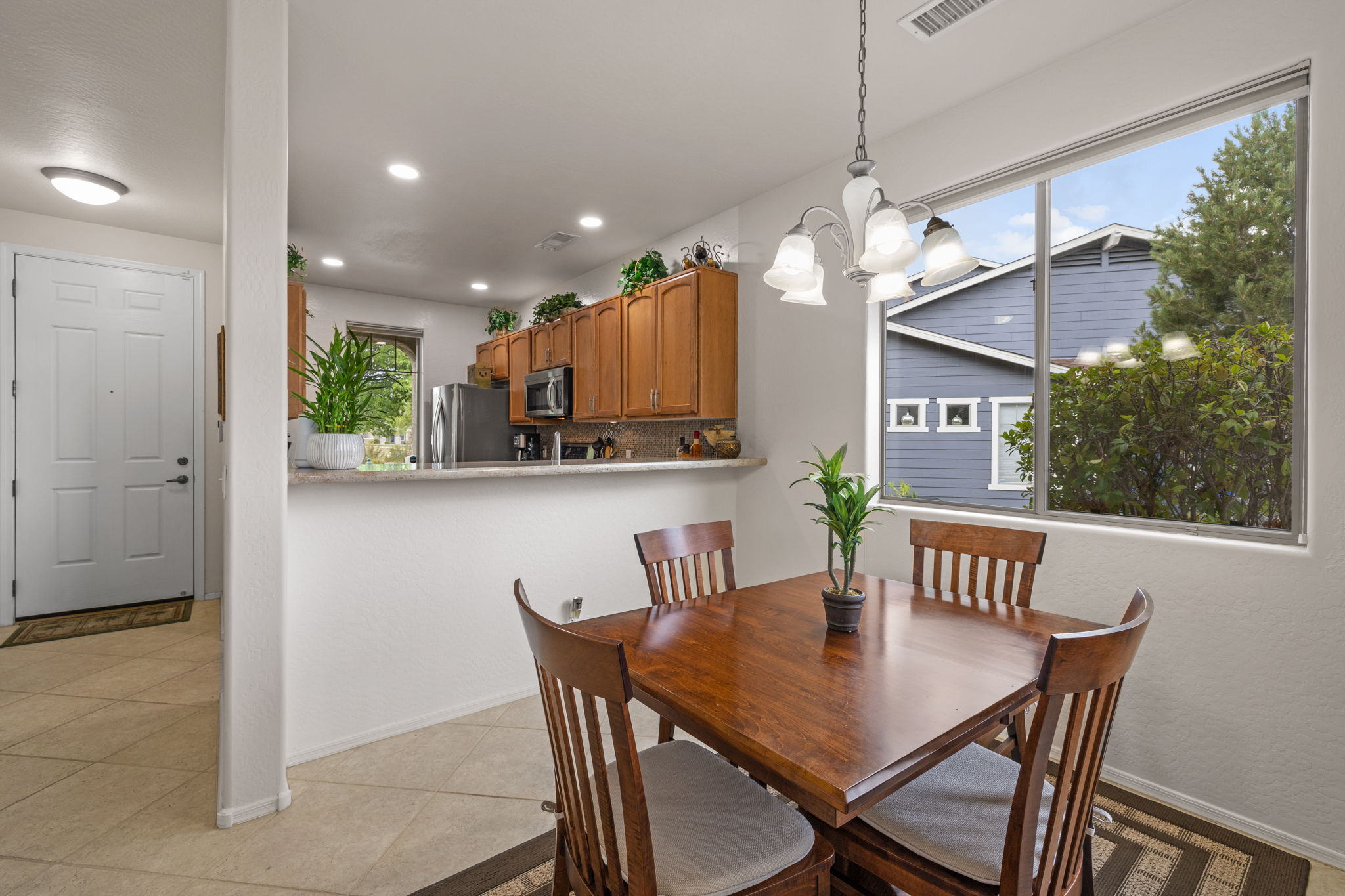 Dining area looking to kitchen and front entry on Left