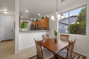 Dining area looking to kitchen and front entry on Left