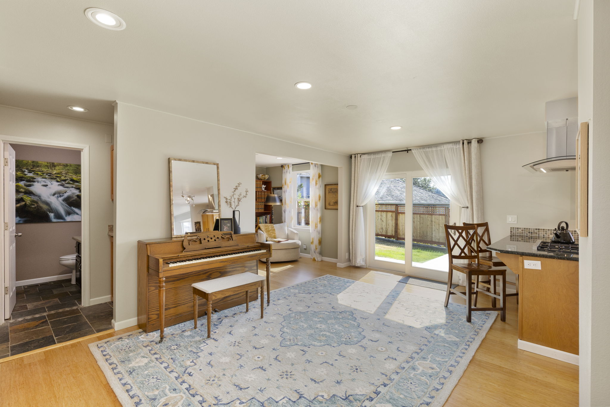 Another living space, addition dining space, rec area? Office/den to left of slider. 1/2 bath and laundry left of piano.