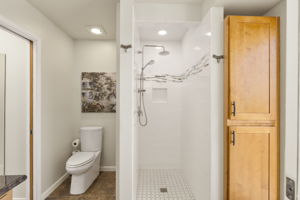 Another shot of primary bathroom with tons of storage and walk in shower.