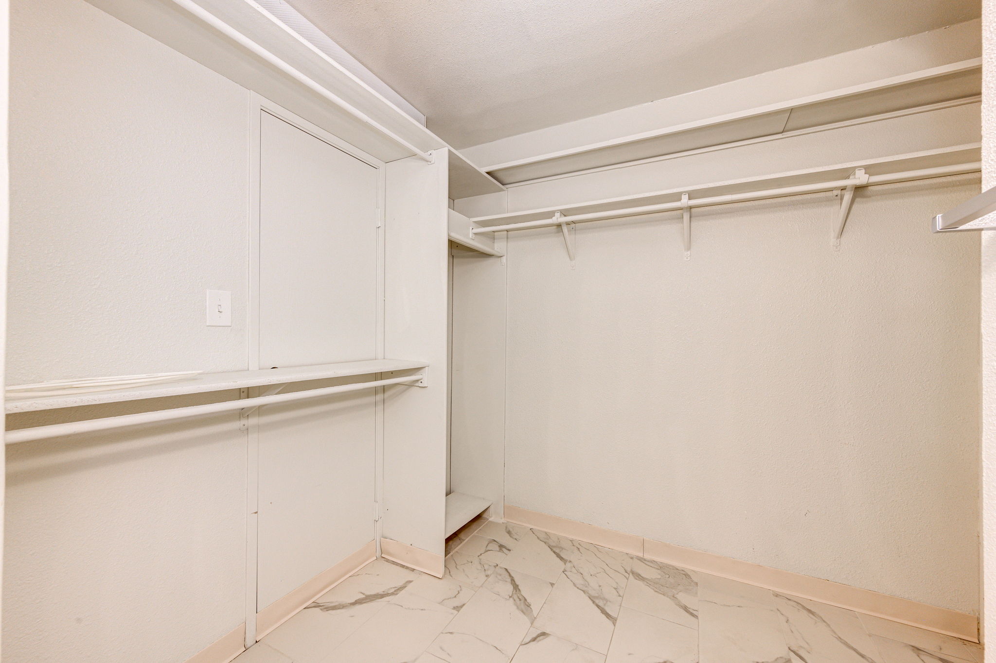 Primary bedroom walk-in closet