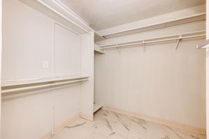 Primary bedroom walk-in closet