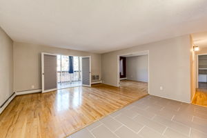 Living room & view of the enclosed balcony area