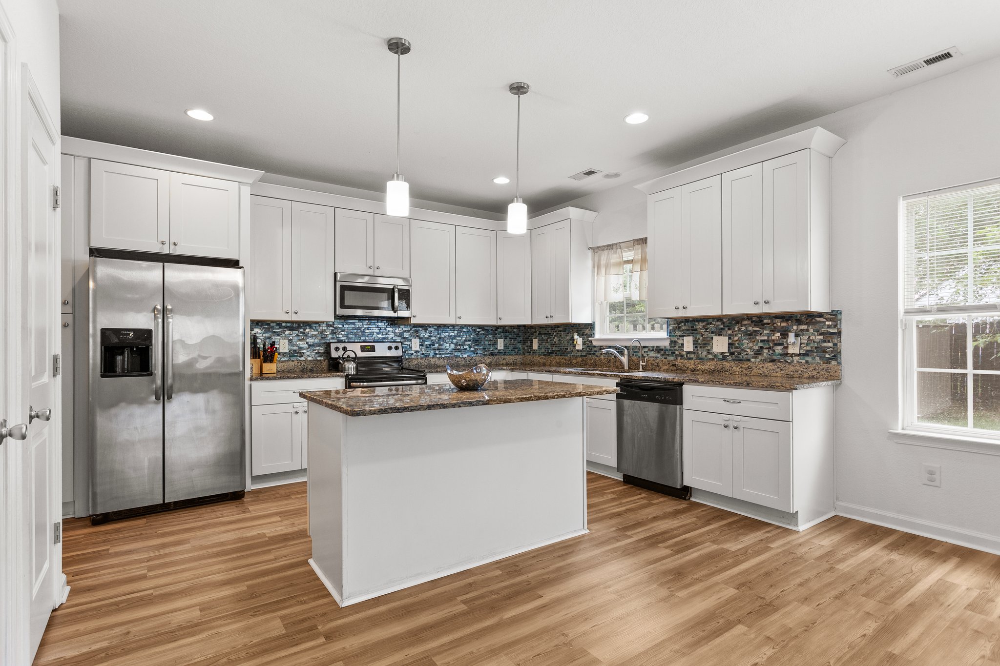 island with white cabinetry & granite