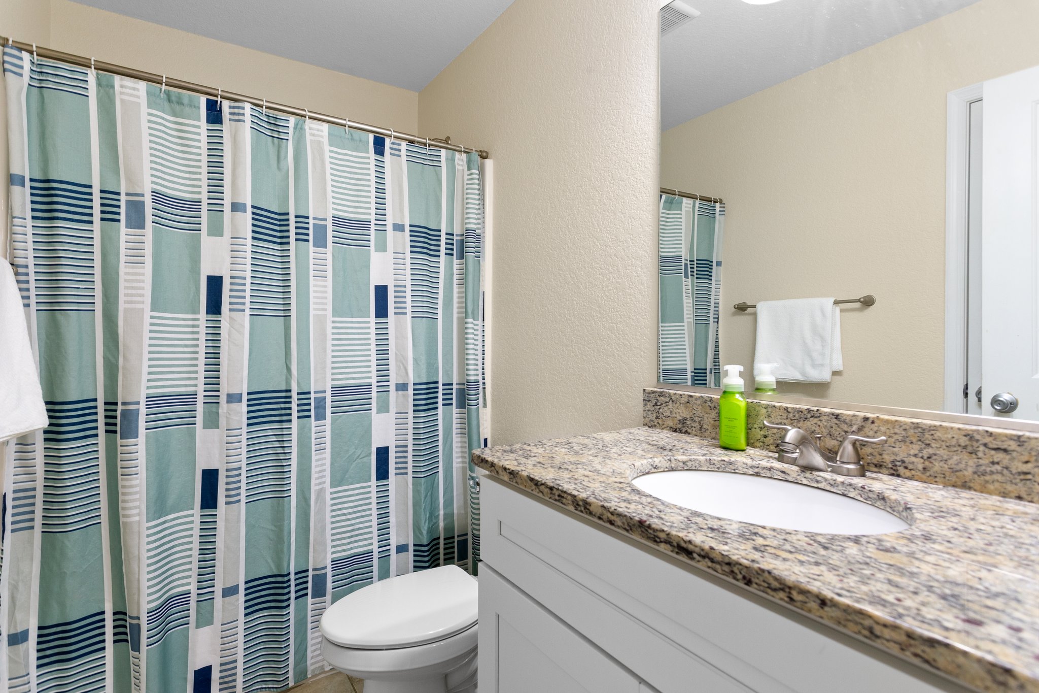 shared hall bath with granite vanity