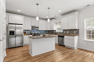 island with white cabinetry & granite