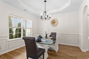 formal dining with lovely molding and tray ceilings