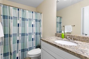 shared hall bath with granite vanity