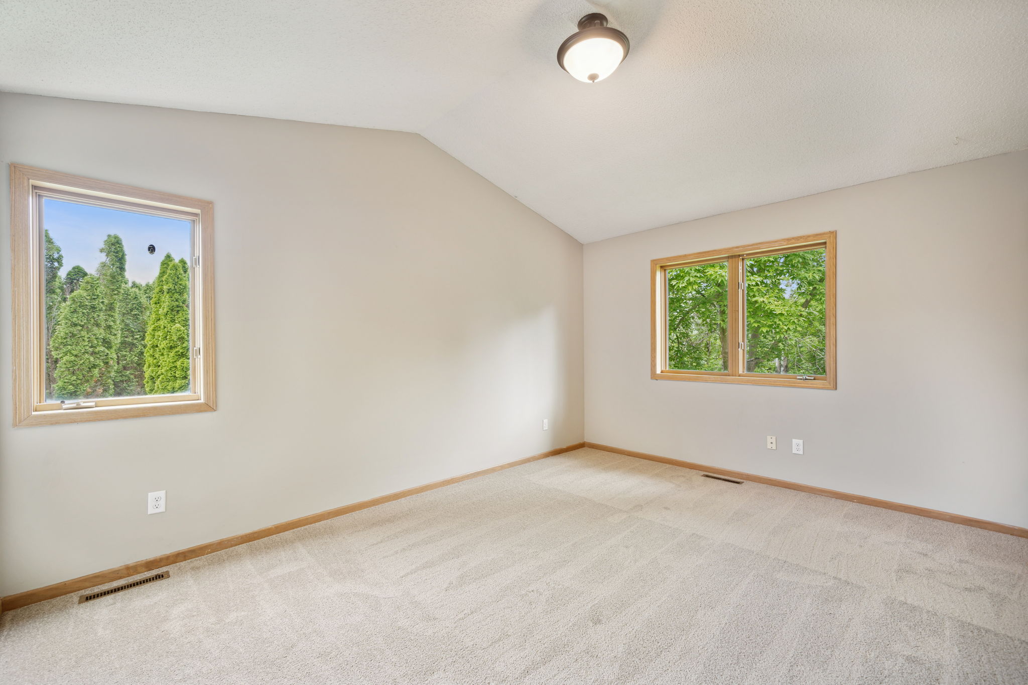 Large 3rd bedroom upstairs has 2 walls with windows and a vaulted ceiling
