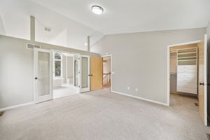 Upstairs in the Primary bedroom, vaulted ceilings, large walk-in closet and remodeled bath