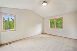 Large 3rd bedroom upstairs has 2 walls with windows and a vaulted ceiling