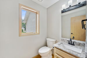 Main floor half bath updated with new lighting and countertop