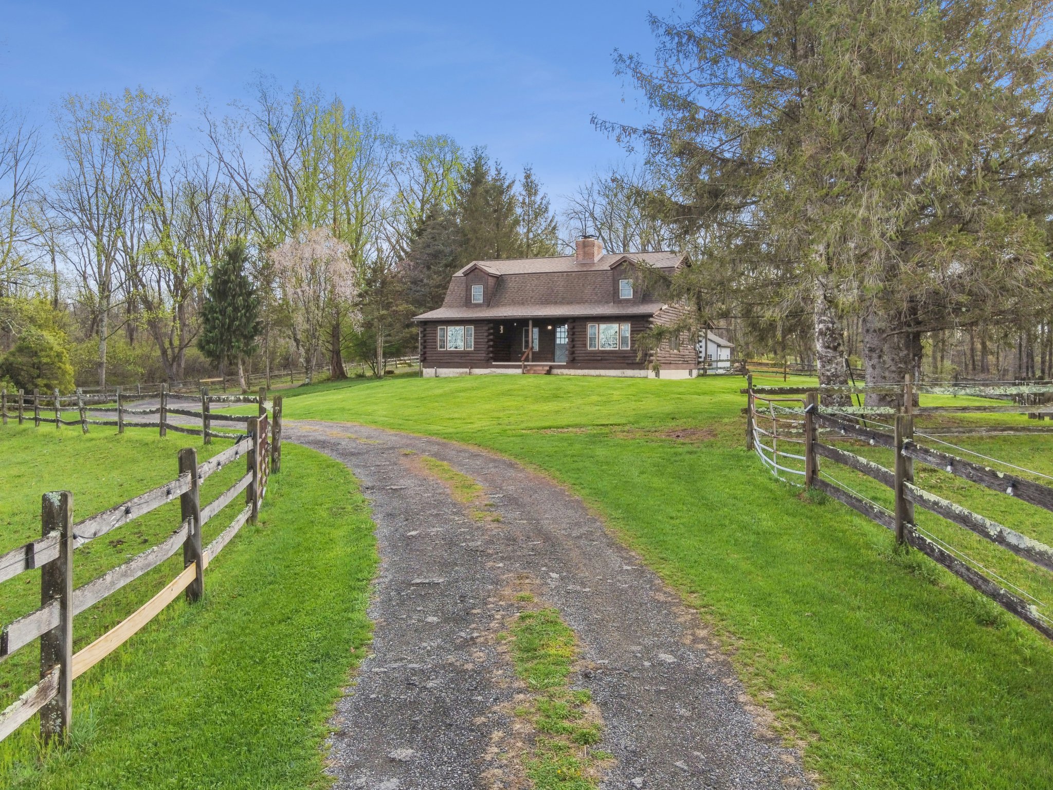 Fenced pastures on both sides of driveway