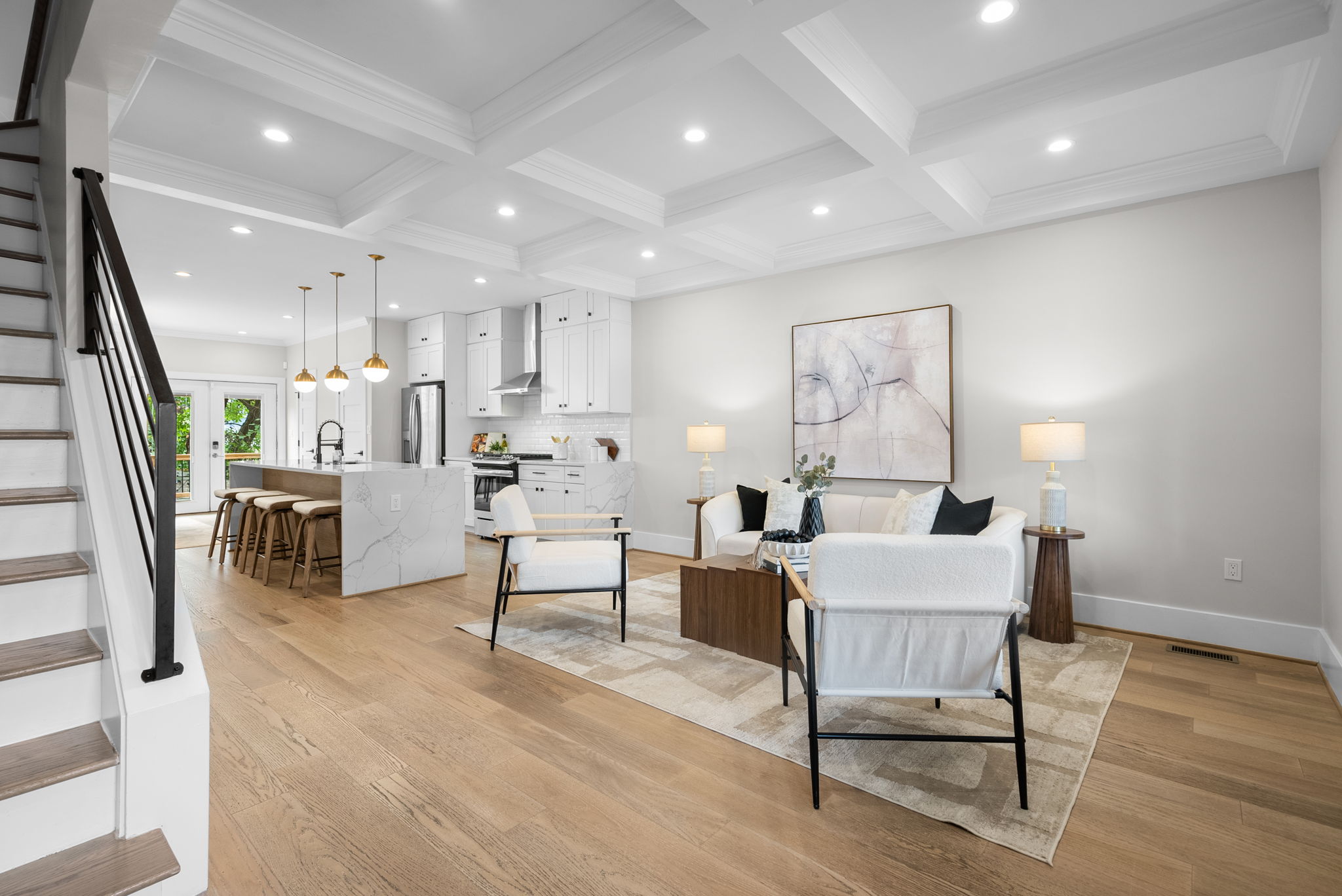 Open main level with coffered ceilings and hardwood floors