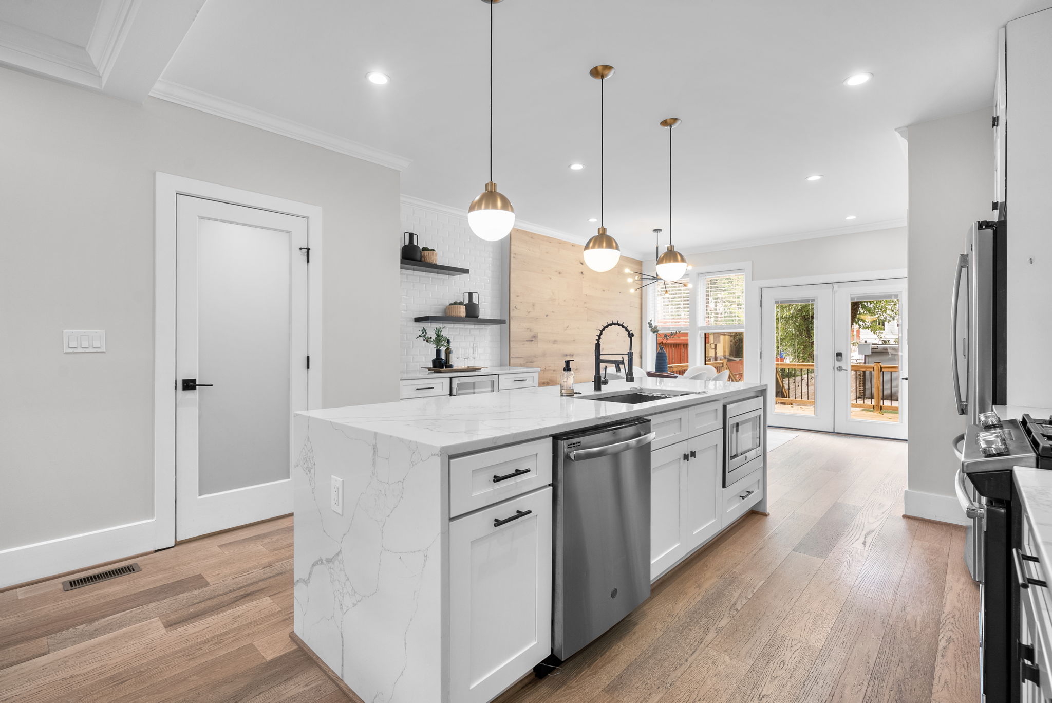 Kitchen island with French doors out to the deck