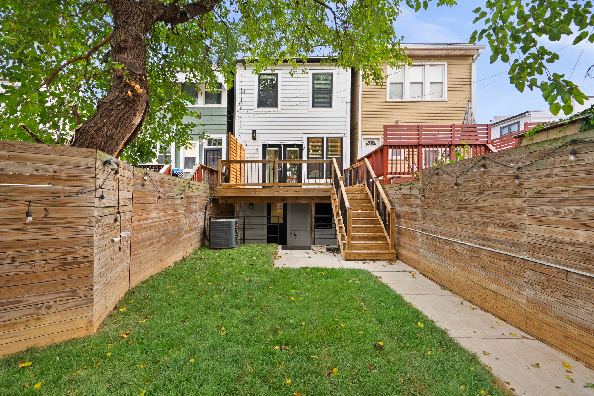 Fenced backyard with mature shade trees
