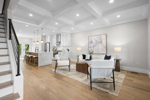 Open main level with coffered ceilings and hardwood floors