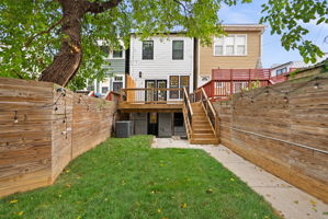 Fenced backyard with mature shade trees