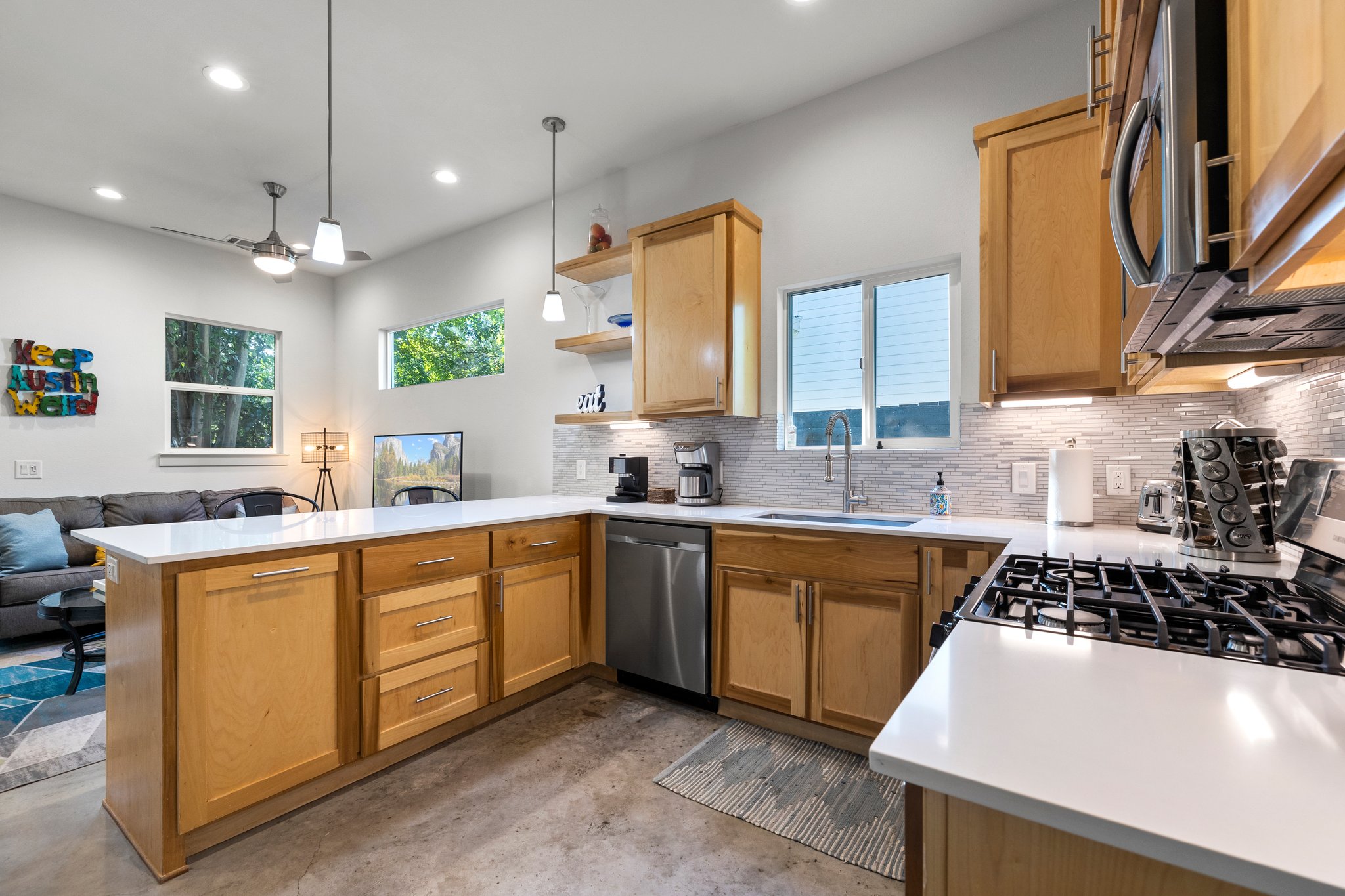 Gorgeous kitchen with maple cabinets, breakfast bar, and natural light. The "Keep Austin Weird" sign does not convey (is not included in the sale).