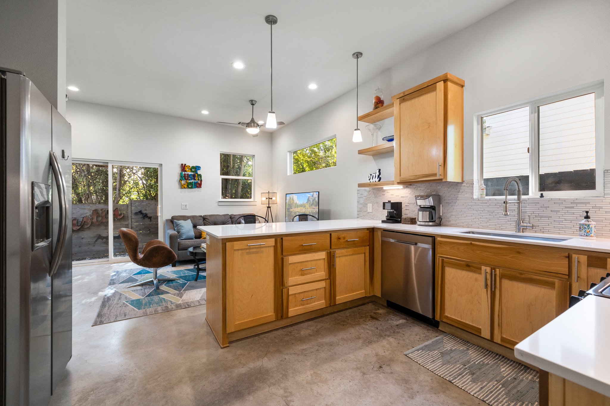 Gorgeous kitchen with maple cabinets, breakfast bar, and natural light. The "Keep Austin Weird" sign does not convey (is not included in the sale).