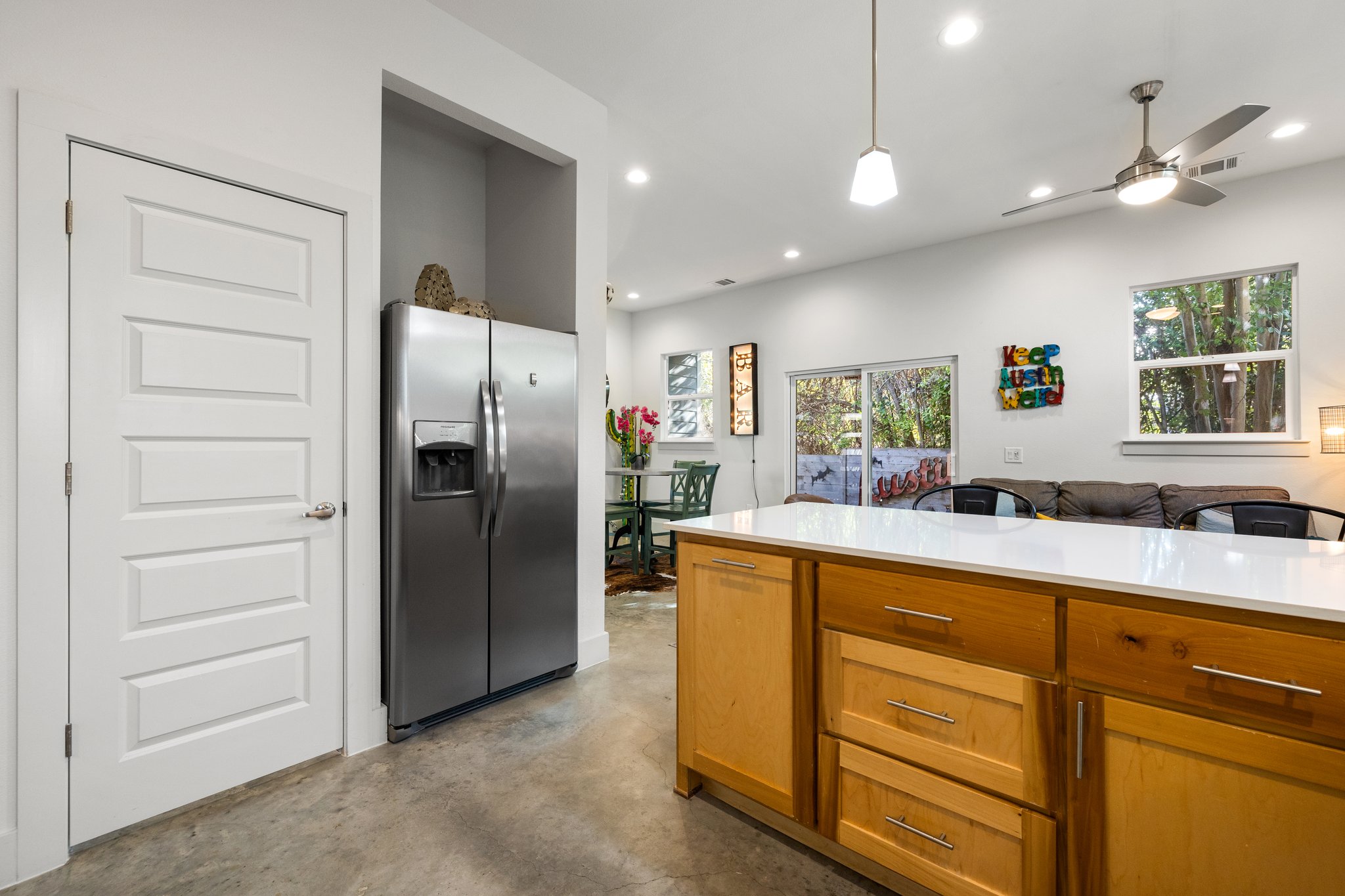 Open floor plan, breakfast bar, and natural light. The "Keep Austin Weird" sign does not convey (is not included in the sale).