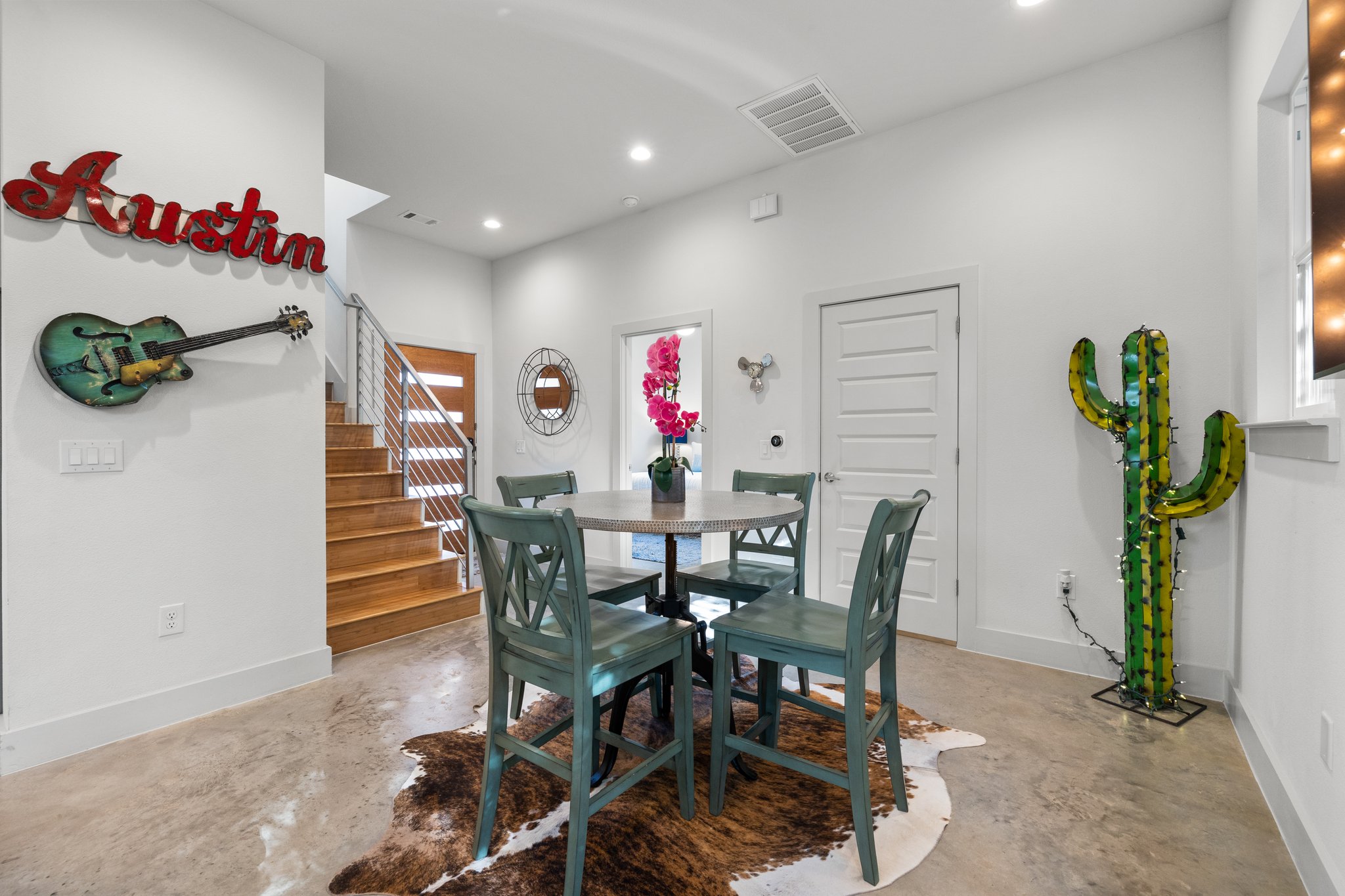 Dining room for four, cement floors, one bedroom on lower level. The "Austin" sign, guitar and cactus do not convey (are not included in the sale).