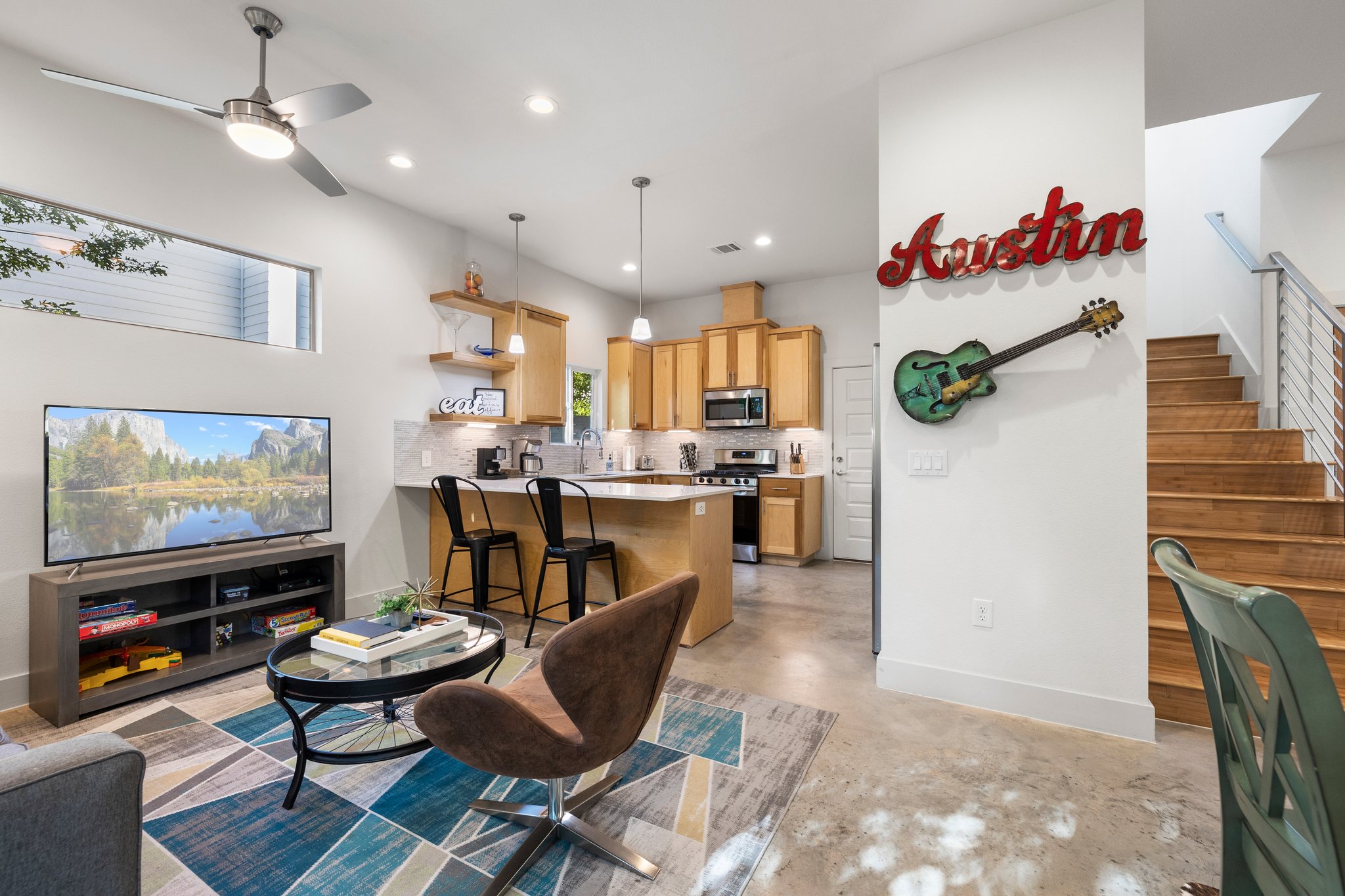 Gorgeous kitchen, relaxing living room, lots of natural light. The "Austin" sign and guitar do not convey (are not included in the sale).
