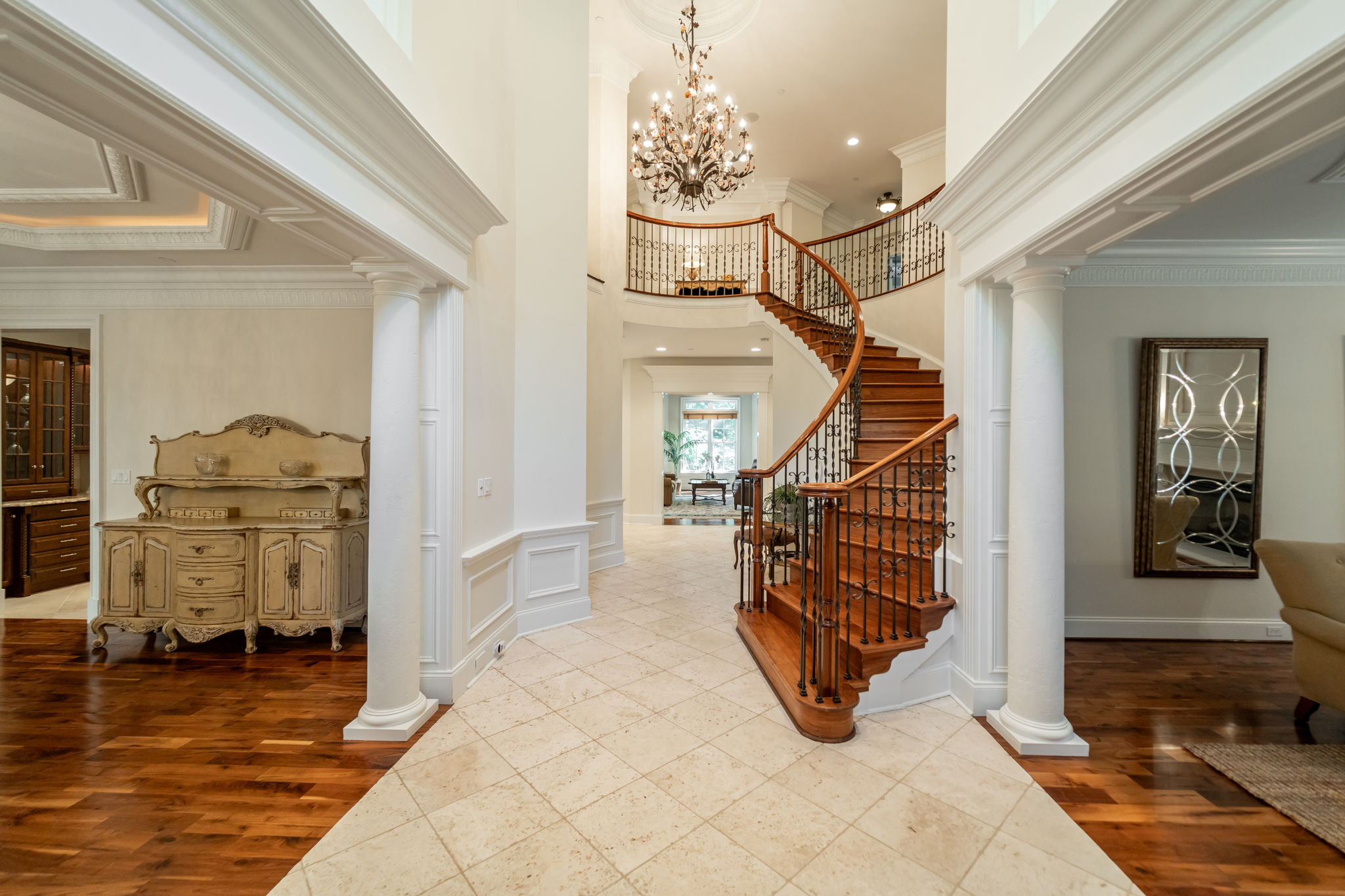 Grand Two Story Foyer with Curved Walnut Staircase