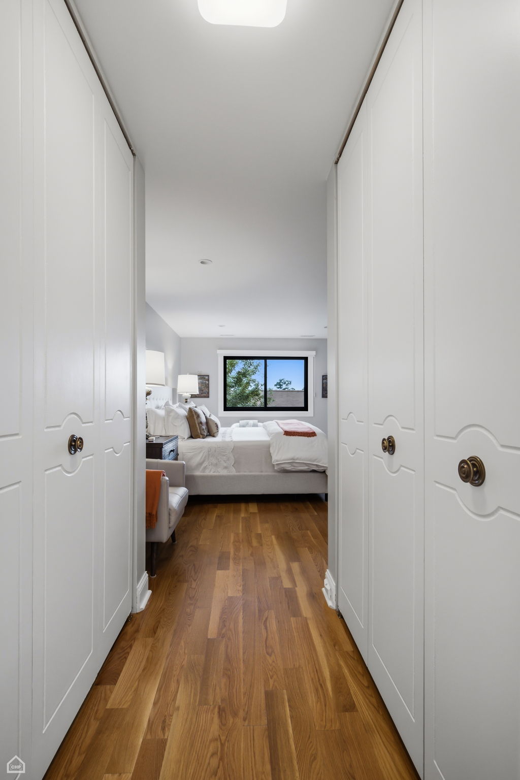 Hallway from primary bedroom to bath is flanked by two oversized closets for exceptional storage