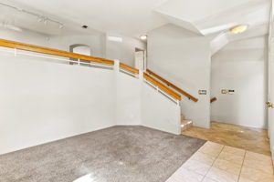 Stairway leads to second level with kitchen.