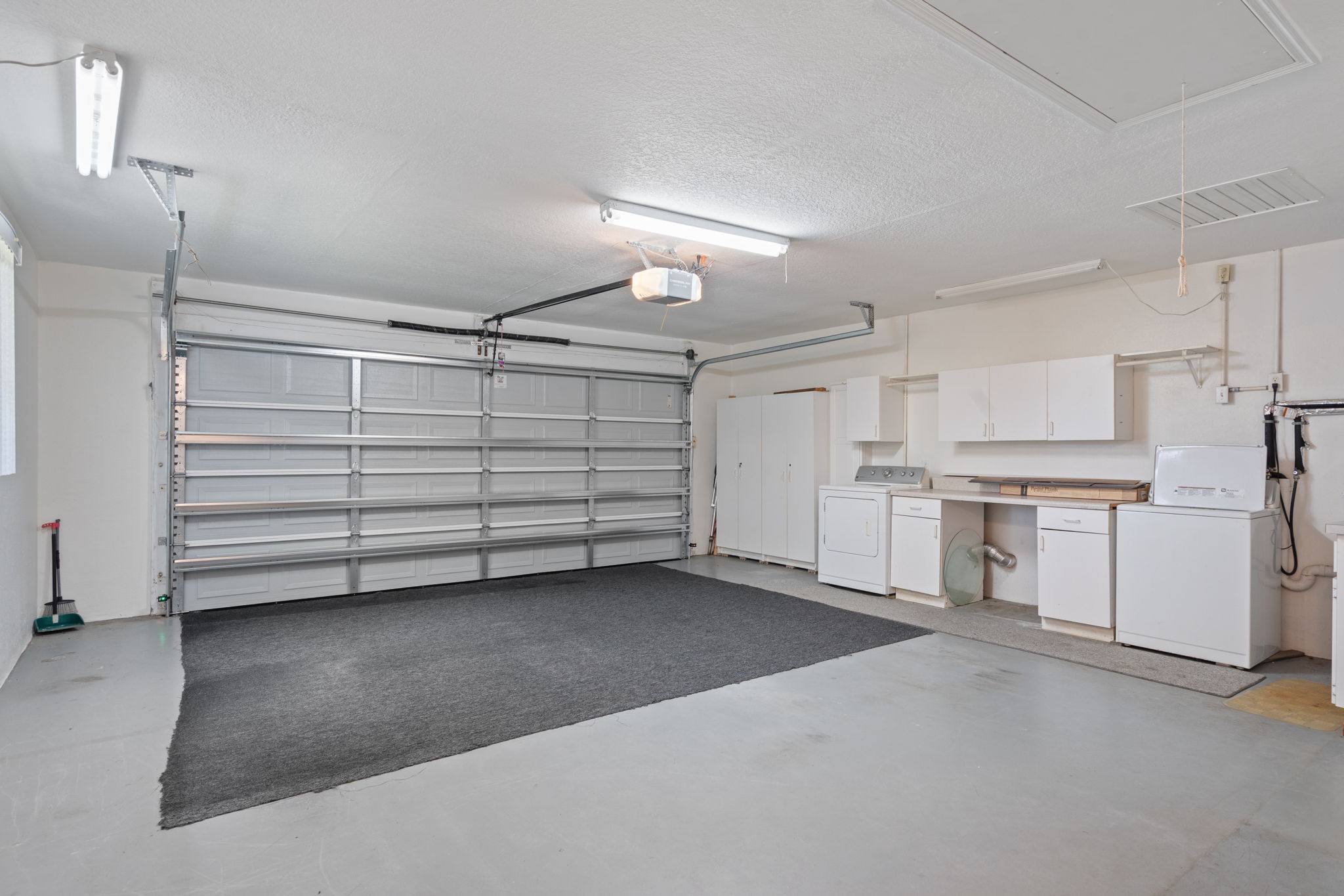 large garage with side entry door and extra storage
