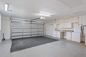 large garage with side entry door and extra storage