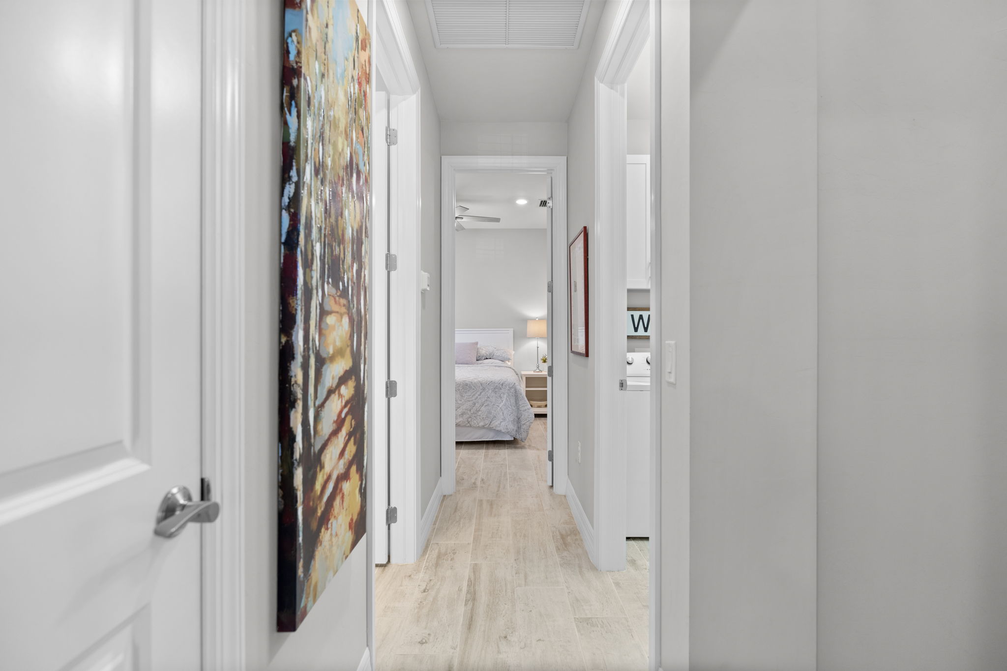 spacious hallway connects guest bedrooms to bathroom