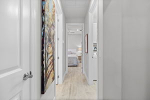 spacious hallway connects guest bedrooms to bathroom